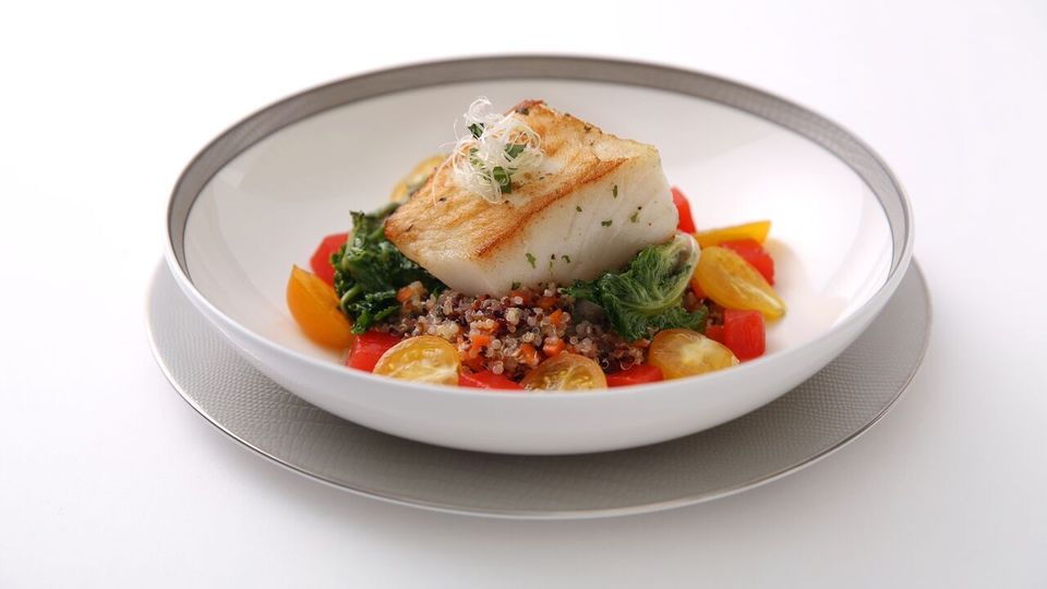 Seared Atlantic salmon is among the menu options on many first-class flights.