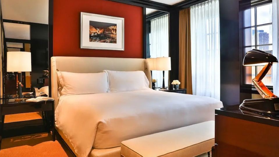 Rooms feature rich red decor and stunning views.
