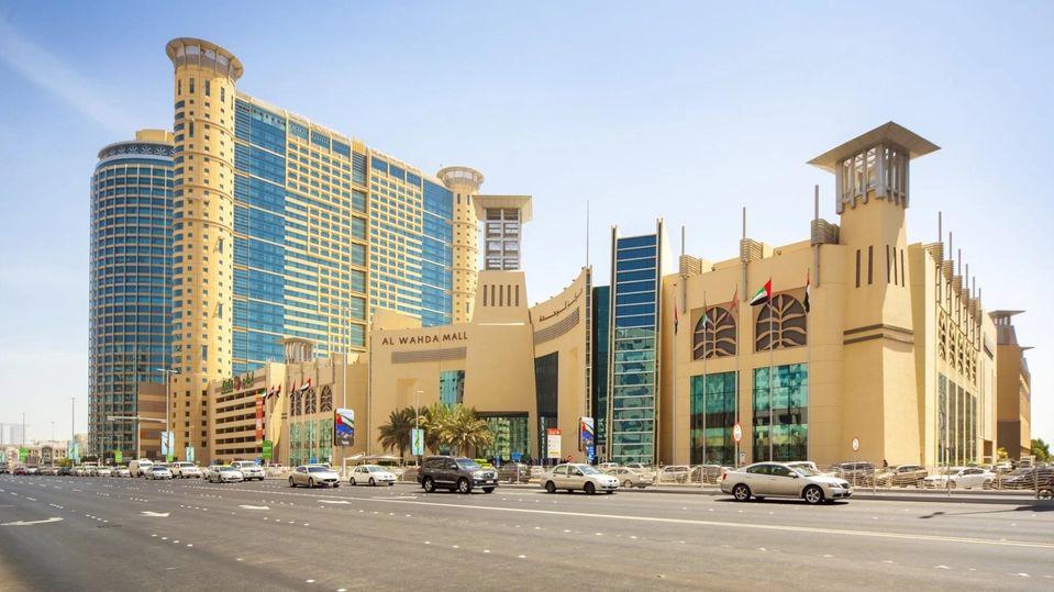 Grand Millennium soars over the Al Wahda shopping centre, one of the largest in the UAE.