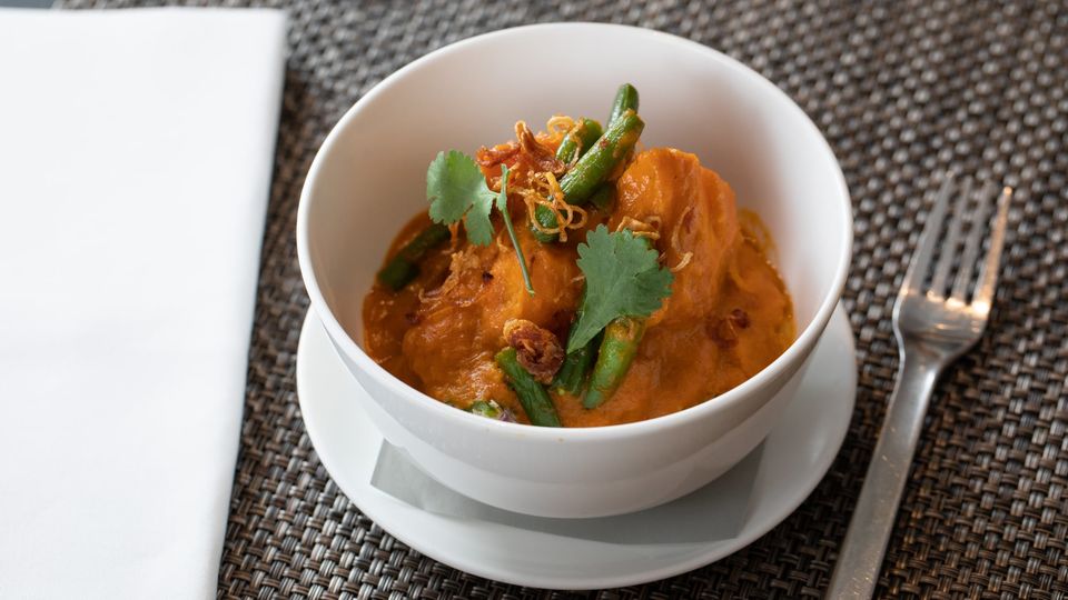 Roast pumpkin with red curry sauce, coconut and green chilli sambal.