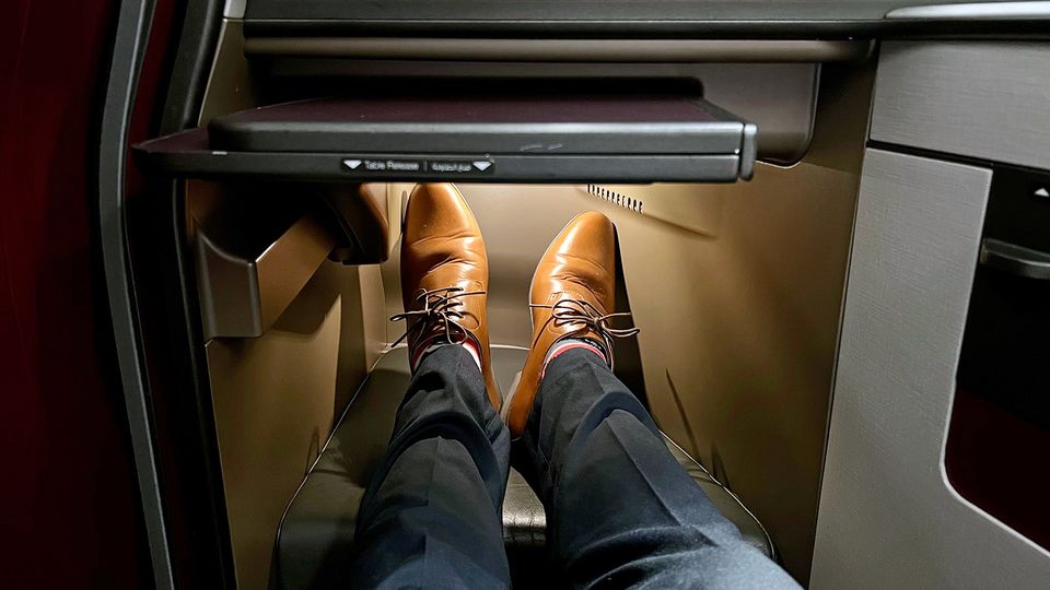 The tray table tucks neatly beneath the monitor, with a touch and pull mechanism to slide it out.