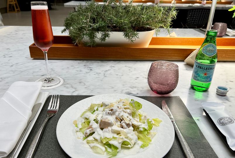 Caesar salad with chicken, and a glass of the Charles Heidsieck Champagne Rosé.