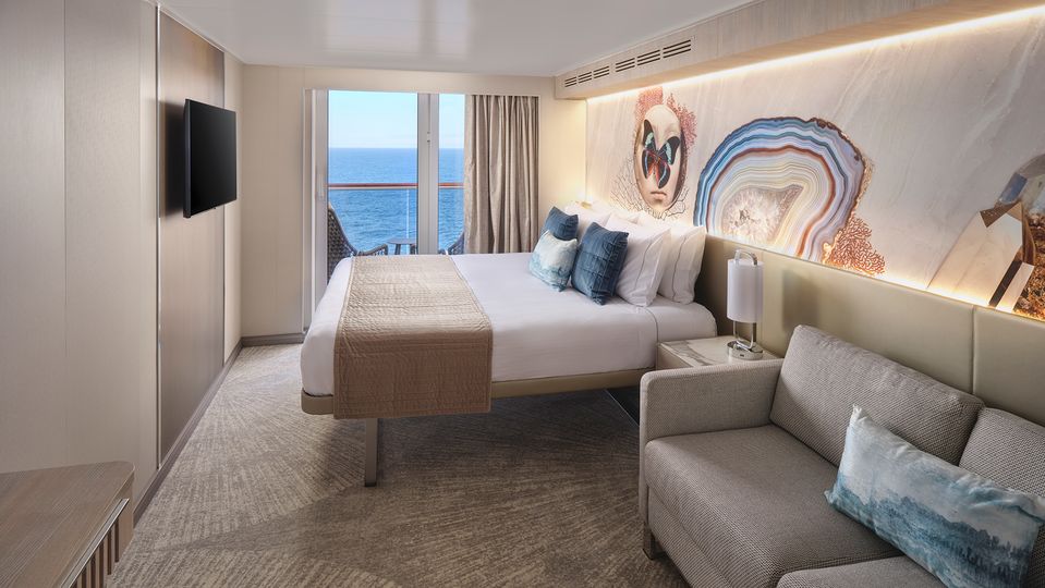 Balcony Staterooms open to a private seating area with small table and chairs.