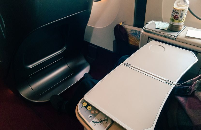 The seat has a large fold-out table, along with a smaller fold-out drinks shelf.