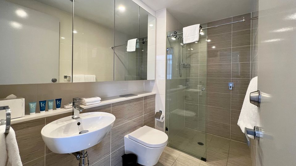 The master bathroom has a shower over the tub, while the second has a walk-in shower.