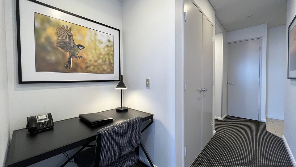 A laundry with washer and dryer is discreetly tucked away in the hall.