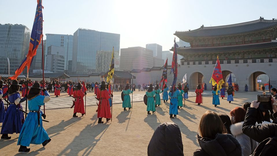 The procession continues toward the main gate.