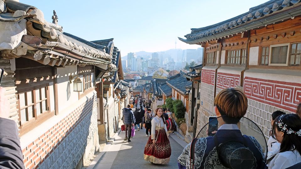The historic Bukchon hanok village, with modern day towers in the distance.