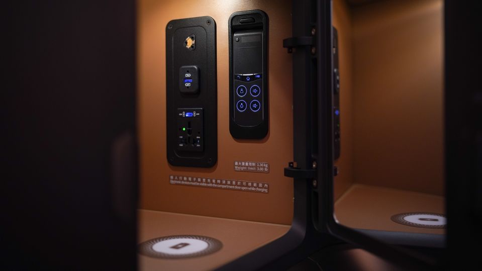 This cabinet in the Starlux A350 business class seat contains USB-A, USB-C and wireless charging (plus a handy little mirror).