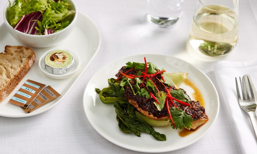 Business class: Seared snapper with black bean sauce and seasonal greens.