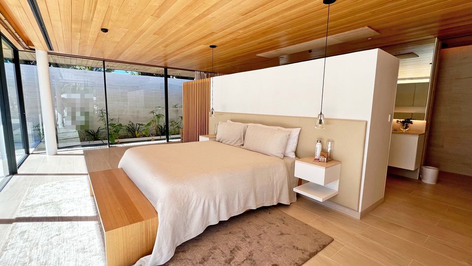 Rooms all follow a similar minimalist aesthetic of clean lines and natural finishes.