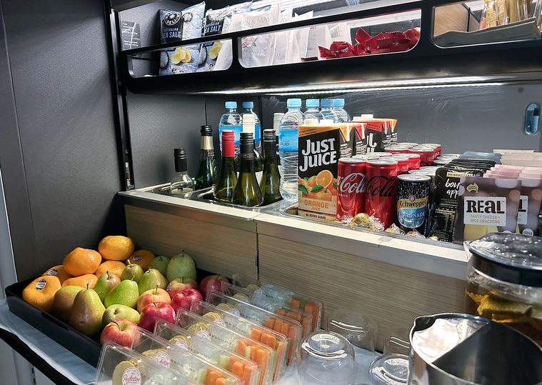 Self-service snacks include fresh fruit, cheese and crackers, chips and chocolate.