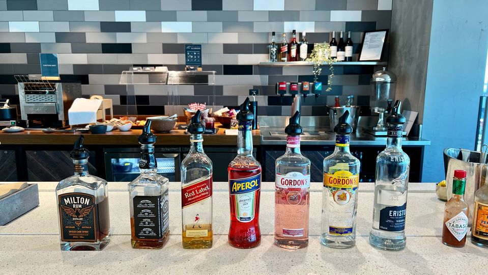 Mixers are found in a low fridge behind the spirits.