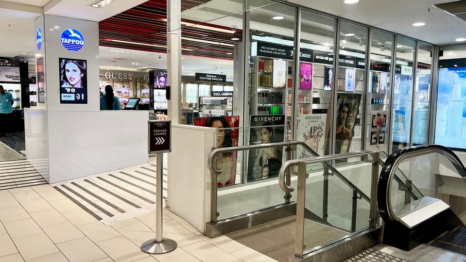 A small metal sign guides the way from the departures hall.