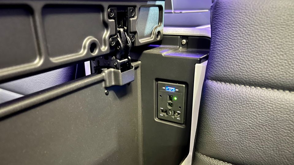The AC and USB sockets are easily accessed beneath the armrest.