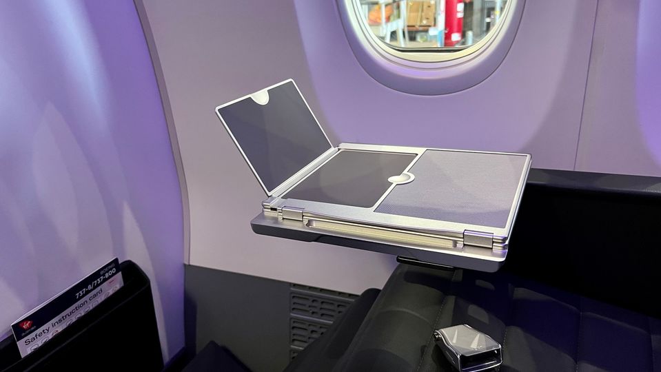 We love this simple, smart and sturdy device holder built into the business class tray table.