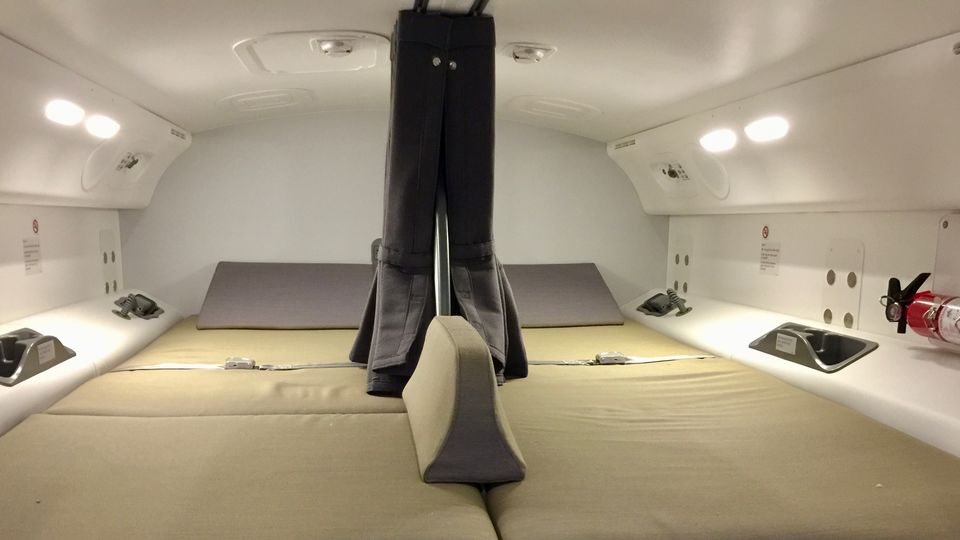 Each of the two pilot rest areas on the Boeing 787 includes cup holders, an intercom and fire extinguisher.