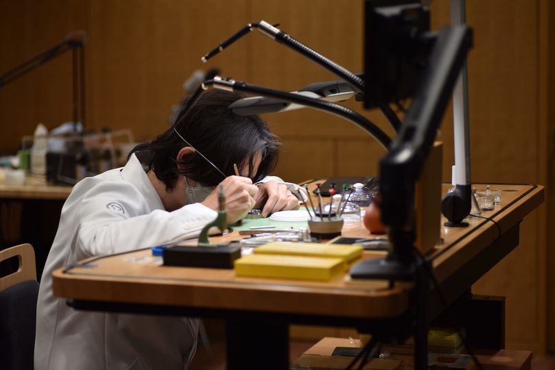Grand Seiko master watchmaker Takuma Kawauchiya assembles a Caliber 9ST movement at the Atelier Ginza.