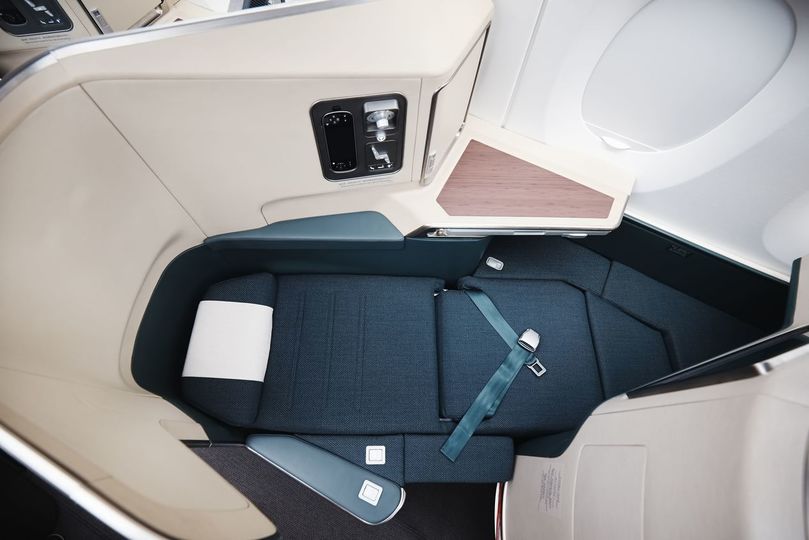 Each business class seat transforms to a lie-flat bed at the touch of a button.