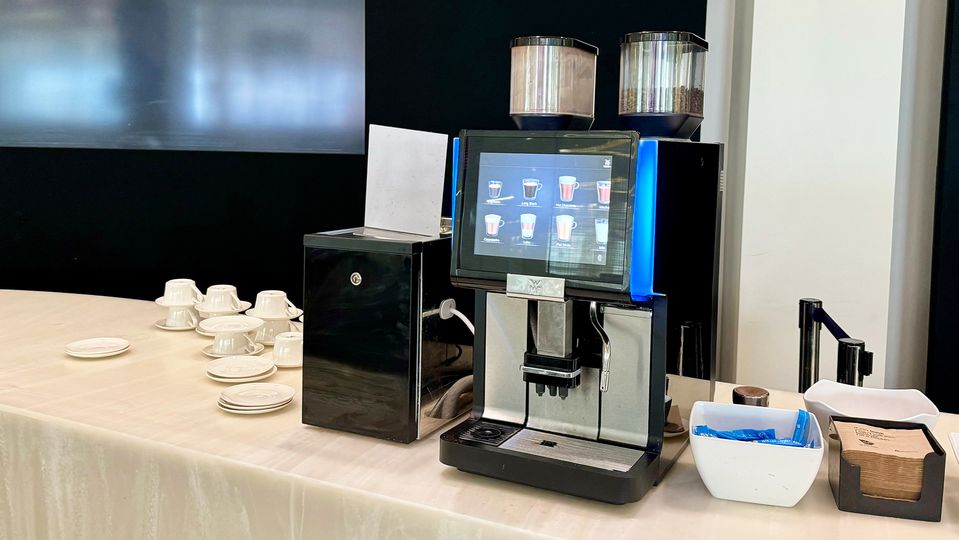The automatic coffee machine is located at the far end of the bar.