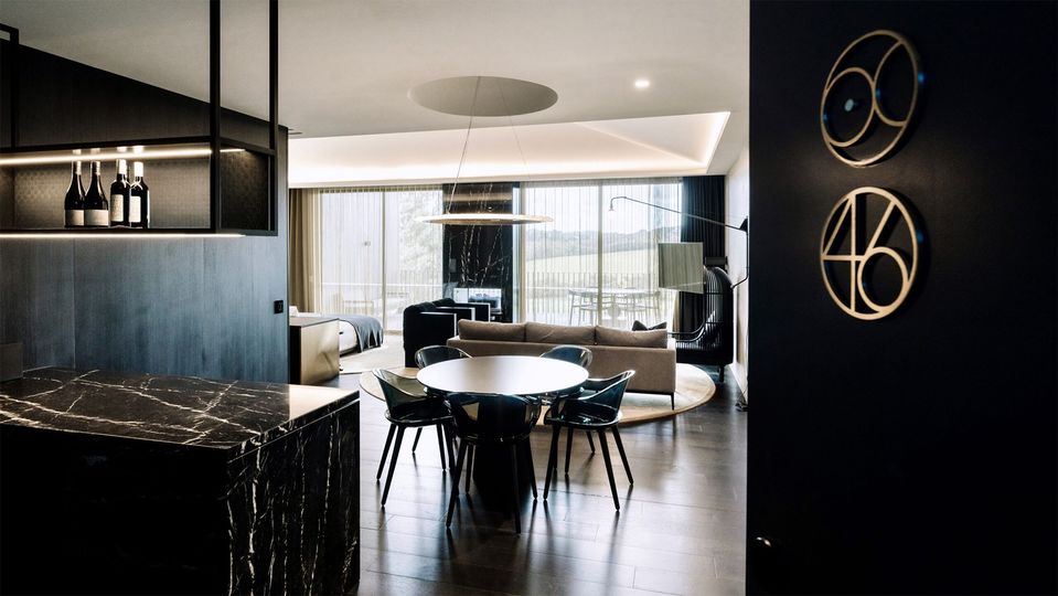 Moody interiors are a stark contrast to the lush greenery outside.