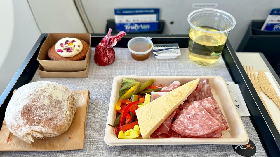 A tasty ploughman's lunch with pickled vegetables, cheese and sliced meats.