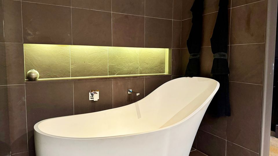A freestanding bath sits alongside the walk-in shower.