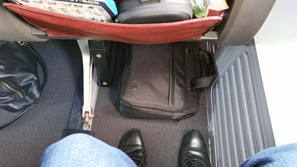 Row 4 on the Qantas 737 provides space enough for comfort and even sliding a small cabin bag under the seat in front...