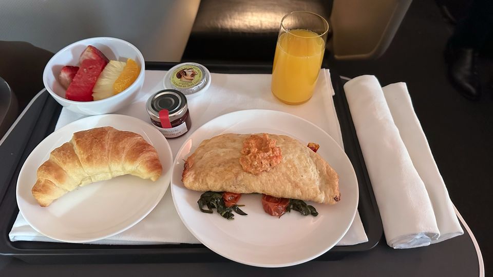 Herbed ricotta and egg white omelette, served with fruit salad and a croissant.
