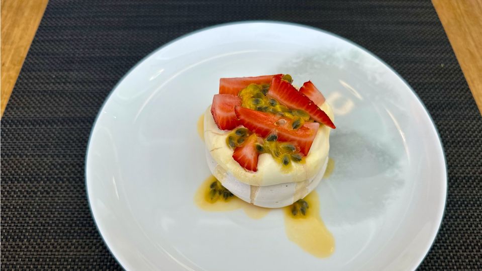 Pavlova with strawberries and passionfruit.