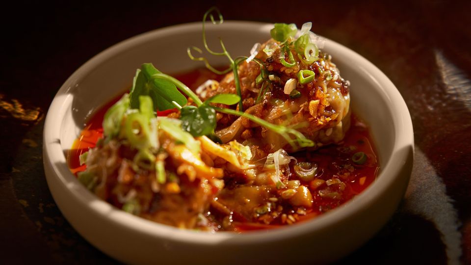 Hand-wrapped Sichuan pork dumplings with chilli sauce.
