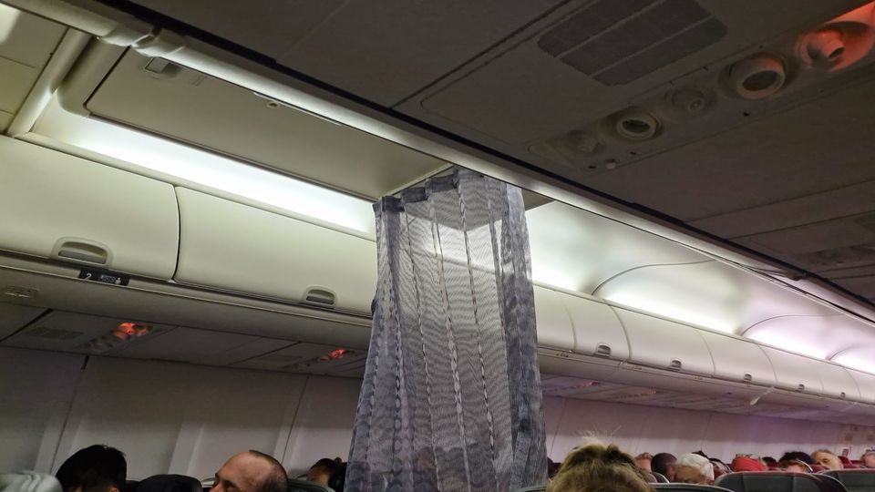 Virgin's new "cross-aisle curtain" between the 737's business and economy cabins.. Ross Anderson