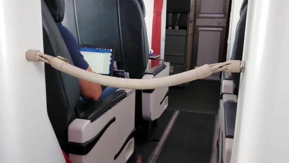 Snake on a plane? The aisle-blocking rope kept economy passengers out of the business lav.