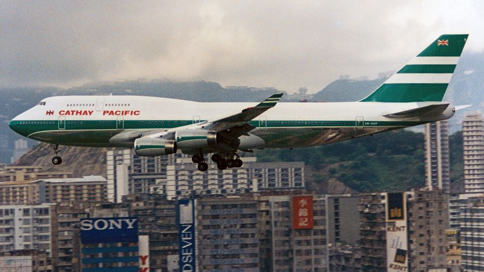 An iconic sight: a Cathay Boeing 747 soars low over Kowloon and into Hong Kong's old Kai Tak Airport.