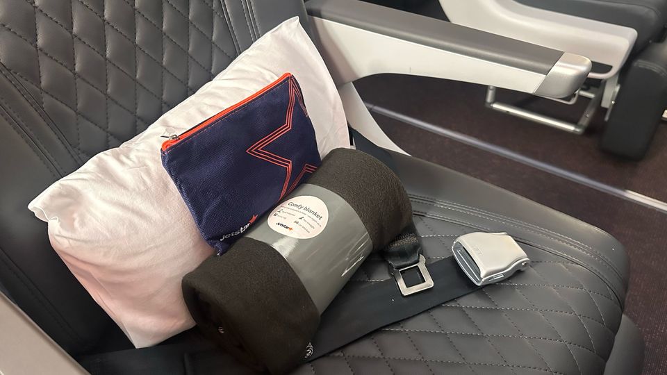Business class comforts include a small pillow, blanket and a basic amenity kit.