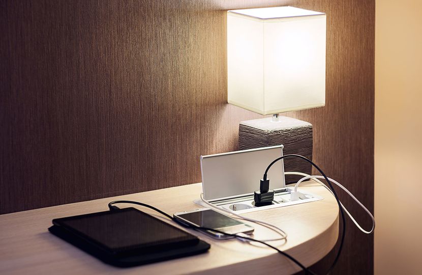 The first rule of hotel rooms: you can never have too many power points.. DepositPhotos