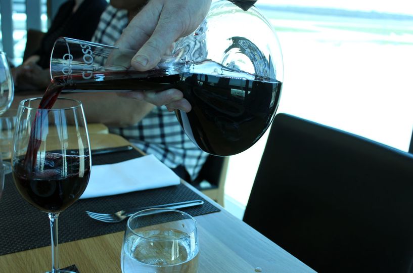 Pouring decanted wine at the Qantas First Lounge, Melbourne